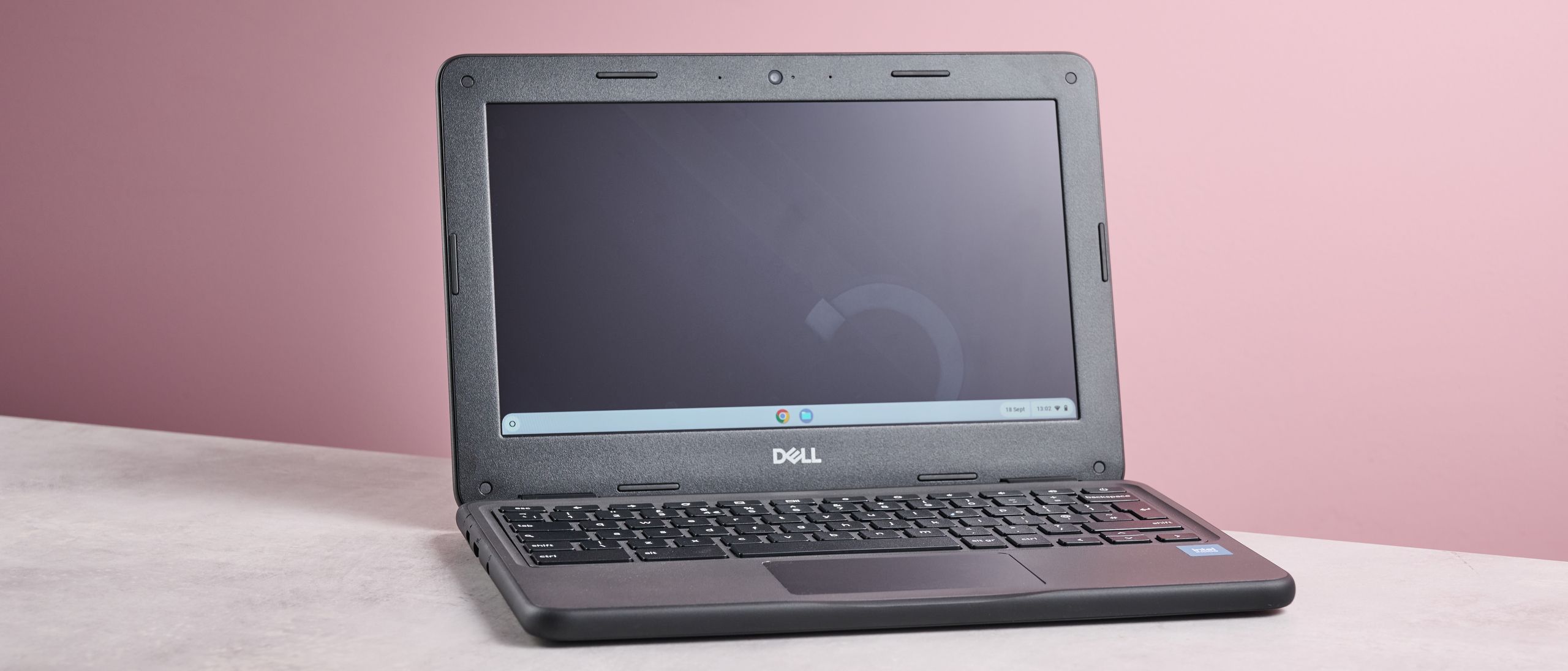 Dell Chromebook 3120 on a desk with study materials