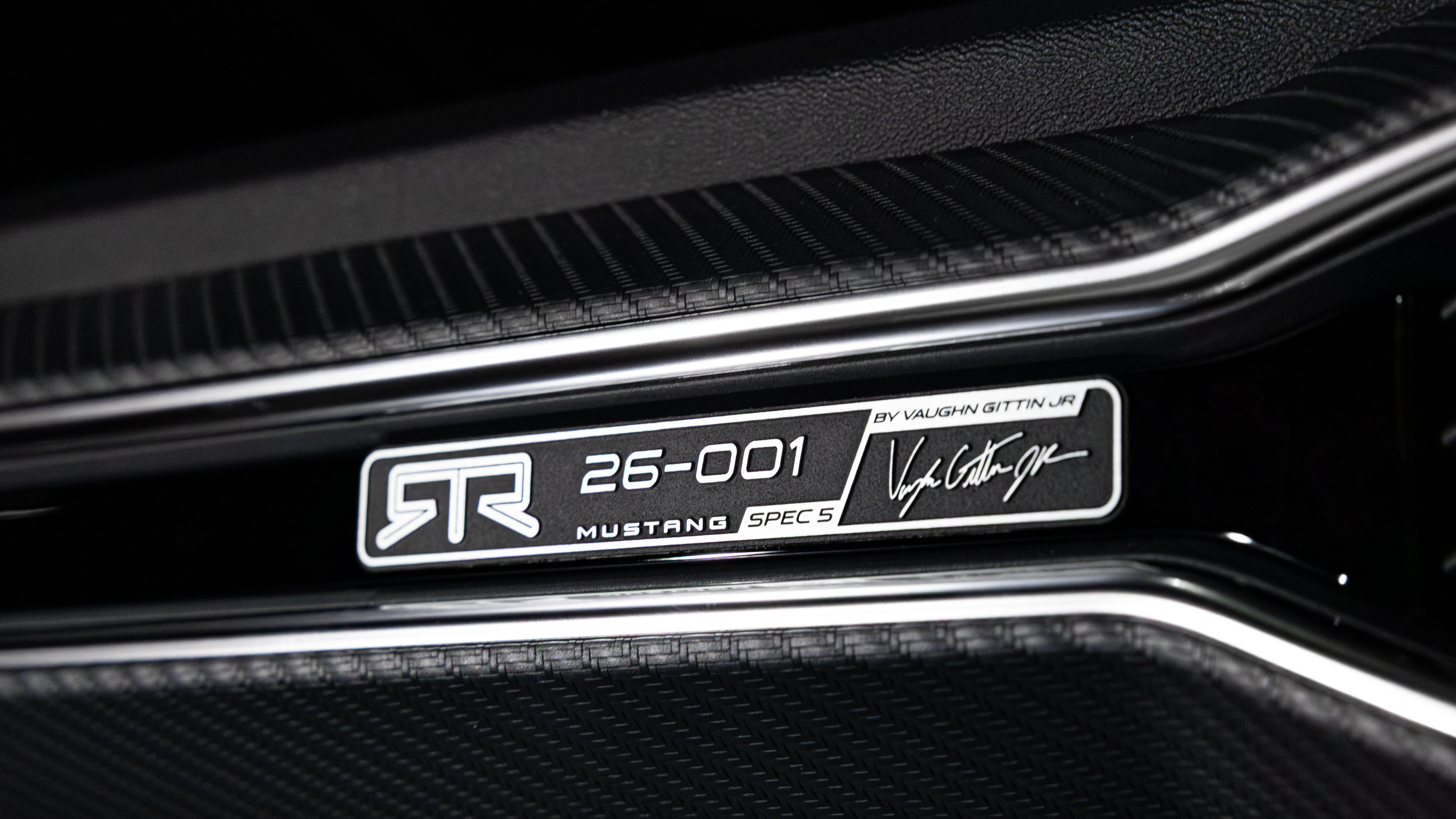 Close-up of the RTR Spec 5 Mustang's front end, showcasing its aggressive grille, integrated LED lighting, and aerodynamic enhancements.