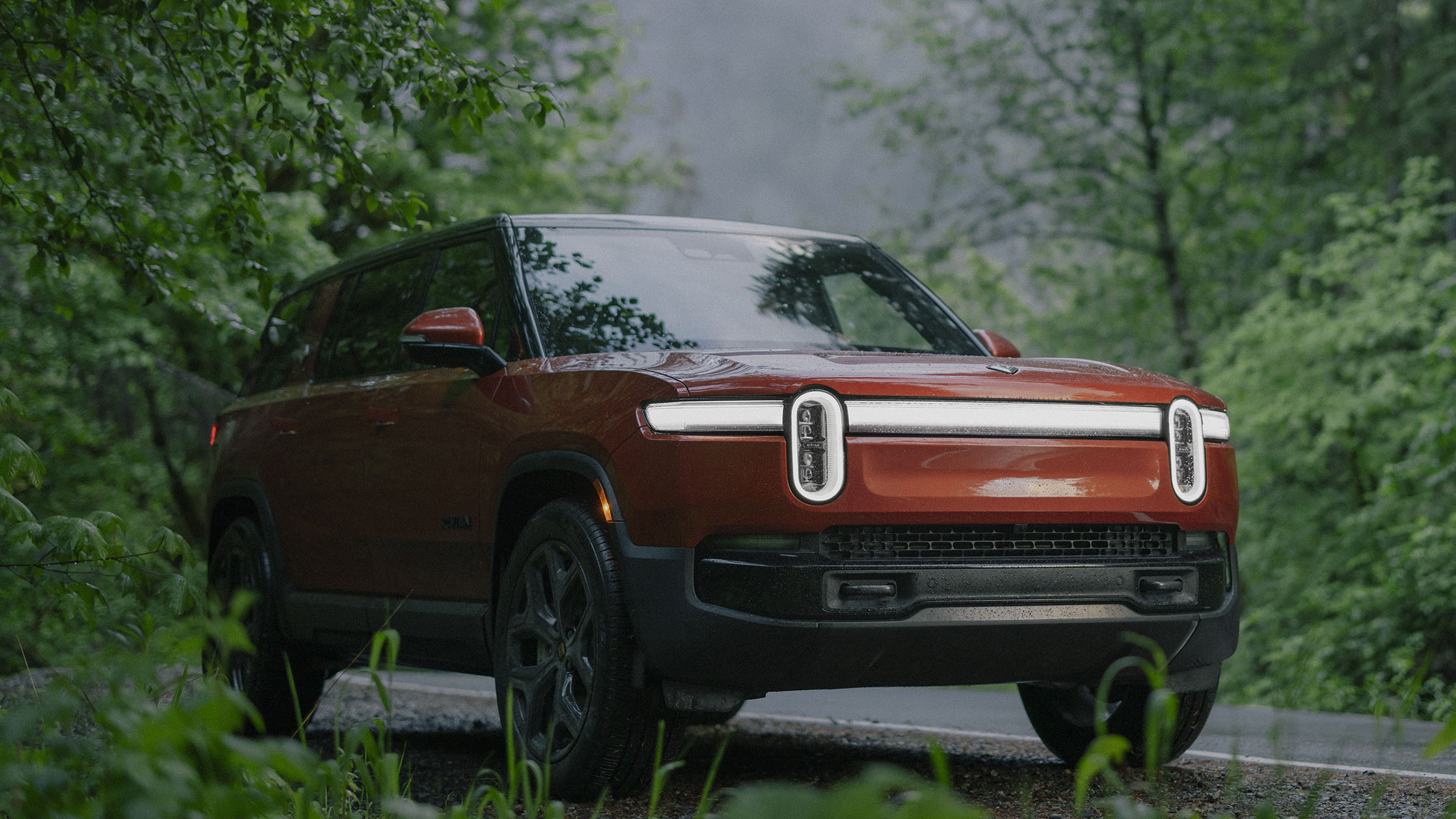 A close-up of the Rivian R1S's charging port, emphasizing the ease of electric vehicle ownership.
