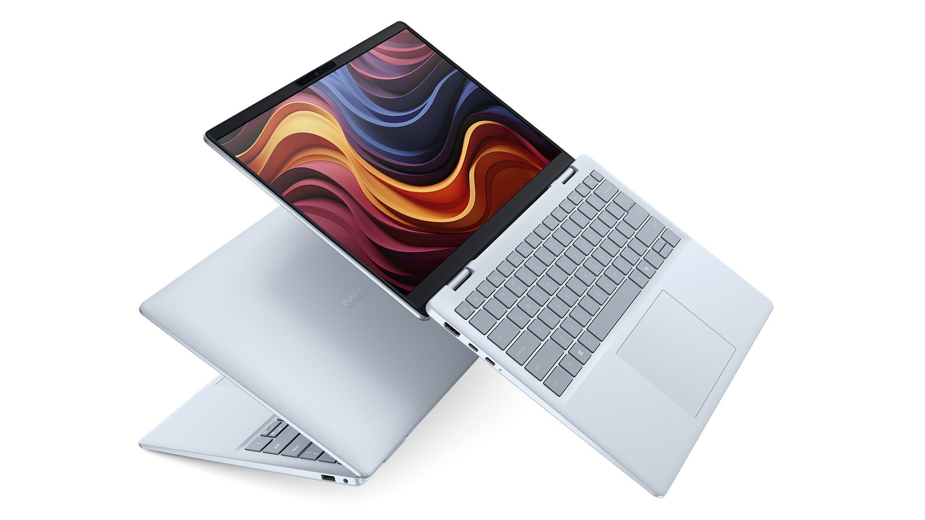 Close-up of a Dell Plus laptop keyboard and trackpad, highlighting its ergonomic design.