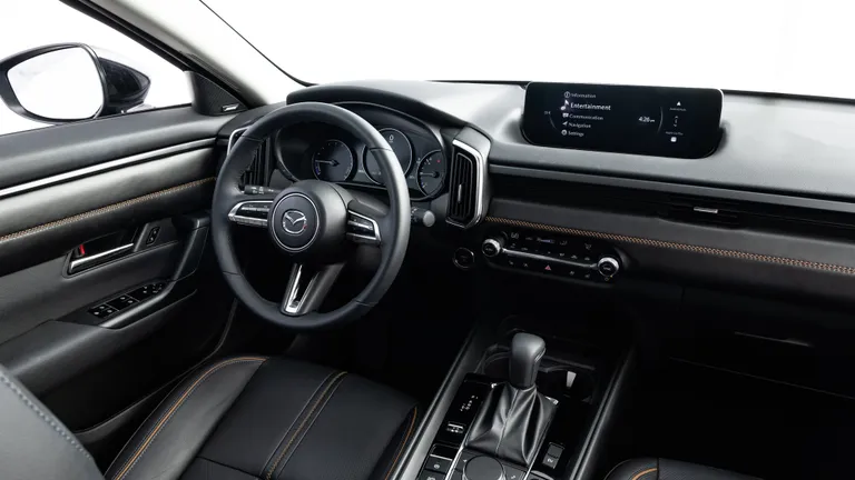 The 2026 Jeep Cherokee Hybrid tackling a challenging off-road trail, demonstrating its off-road capabilities