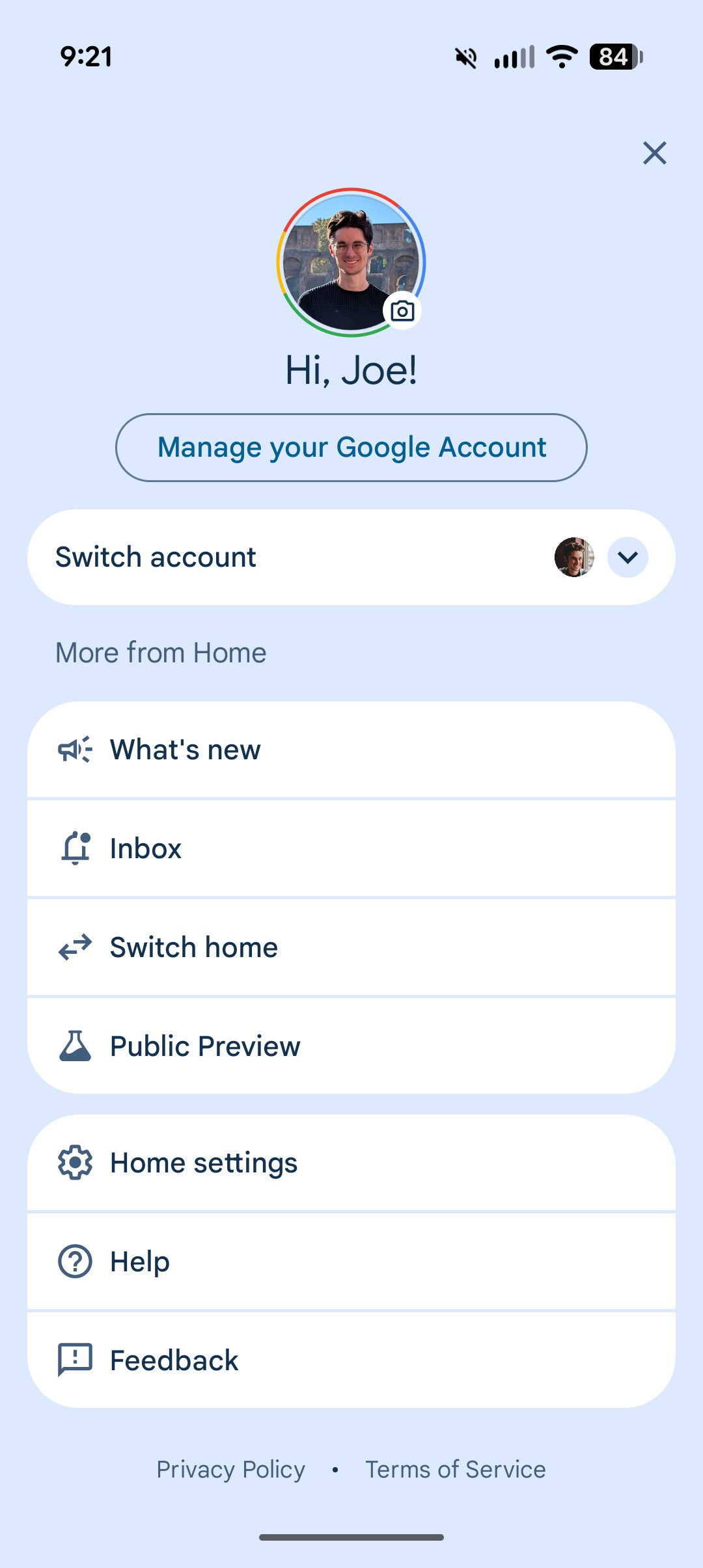 A person interacting with a Google Home smart speaker, demonstrating voice commands.