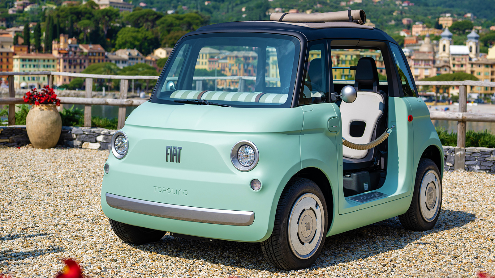 Fiat Topolino U.S. launch: A charming view of the electric Topolino, set to redefine urban commutes. Fiat Topolino U.S. launch: The adorable microcar in a vibrant setting, showcasing its compact design and electric appeal.