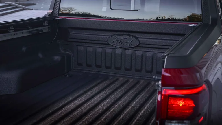 A full-length side profile of the 2026 Ford Maverick in a vibrant green, highlighting its compact and balanced proportions against a natural backdrop.