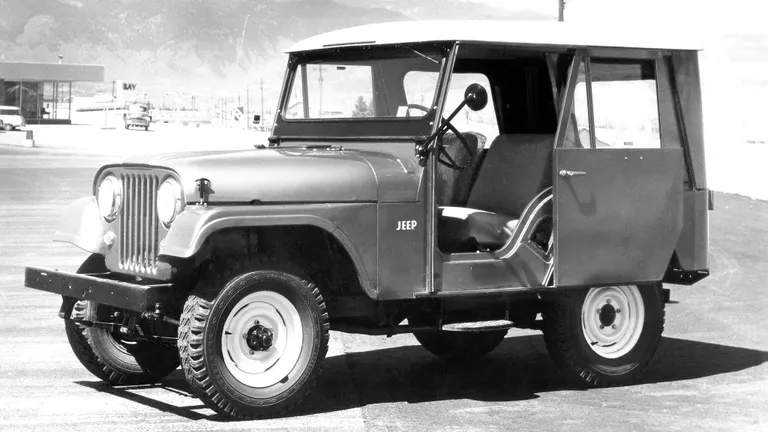 The 2026 Jeep Wrangler Whitecap navigating challenging off-road terrain, demonstrating its robust capabilities and the striking contrast of its Arctic White hardtop against a natural backdrop.