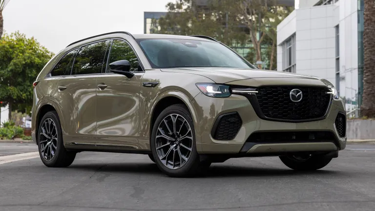 A Mazda CX-70 driving on a road, symbolizing the continuous journey where rattles and squeaks might emerge.