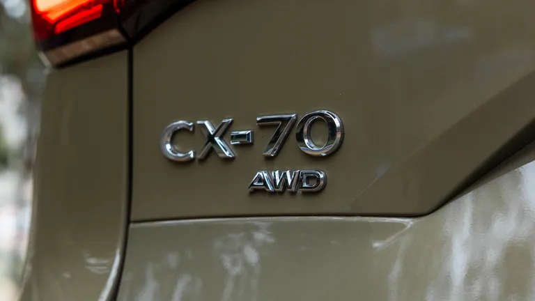Close-up of a Mazda CX-70's B-pillar interior panel, a common source of rattles and squeaks.