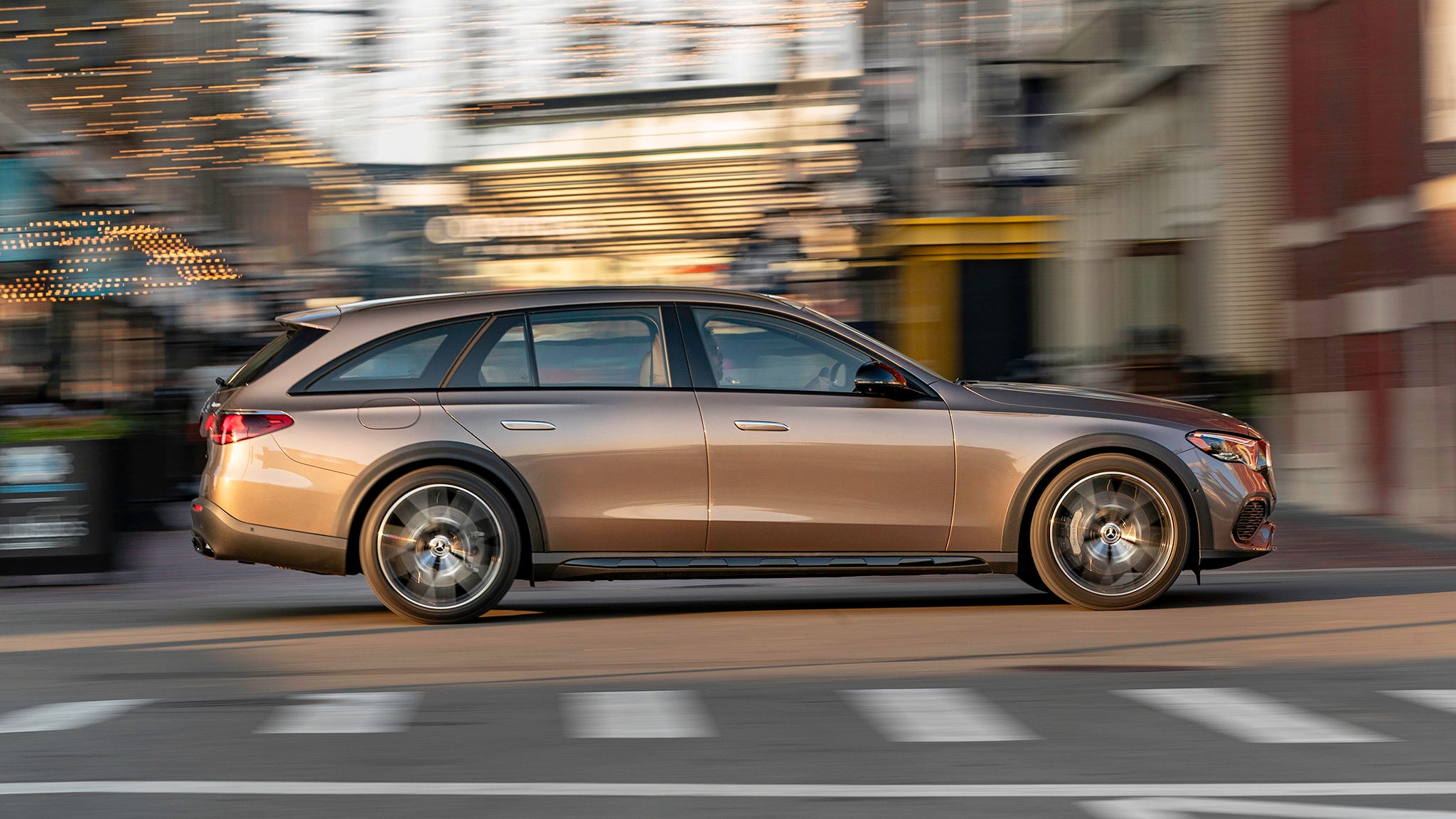 Mercedes-Benz E450 All-Terrain Wagon gracefully navigating a scenic route, highlighting its plush ride.