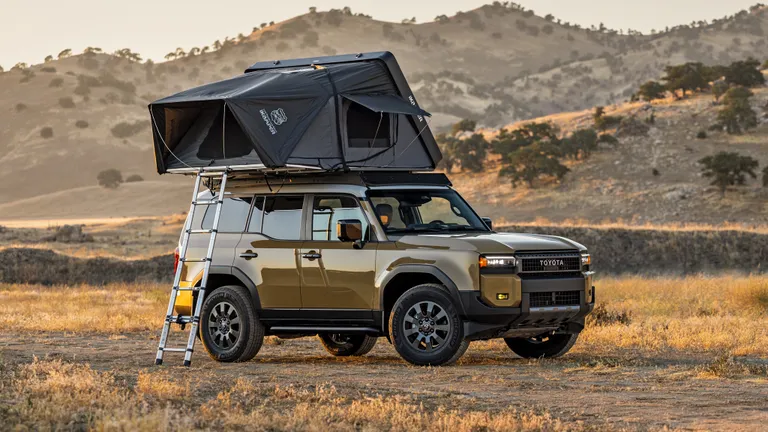 The iKamper Skycamp DLX rooftop tent in its compact, closed state on a vehicle