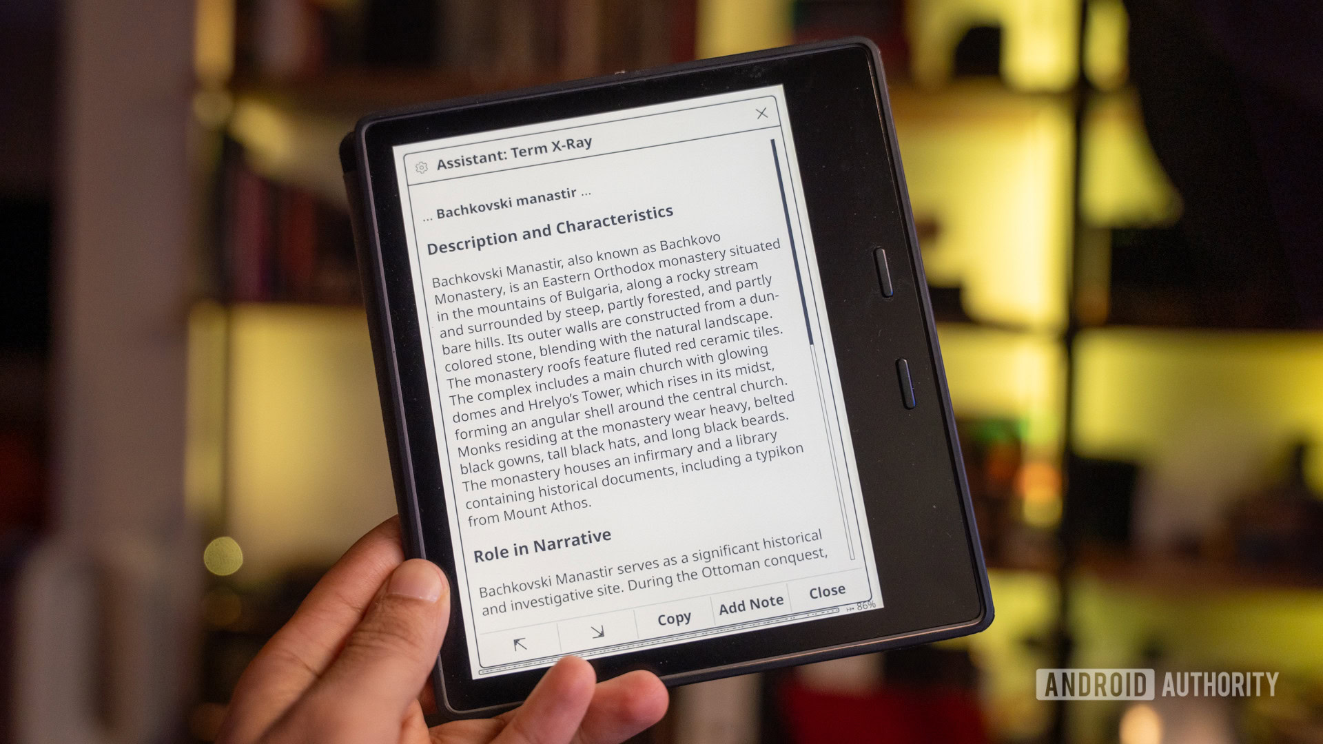 A Kindle e-reader displaying a book with an overlay showing Google Gemini AI providing a summary
