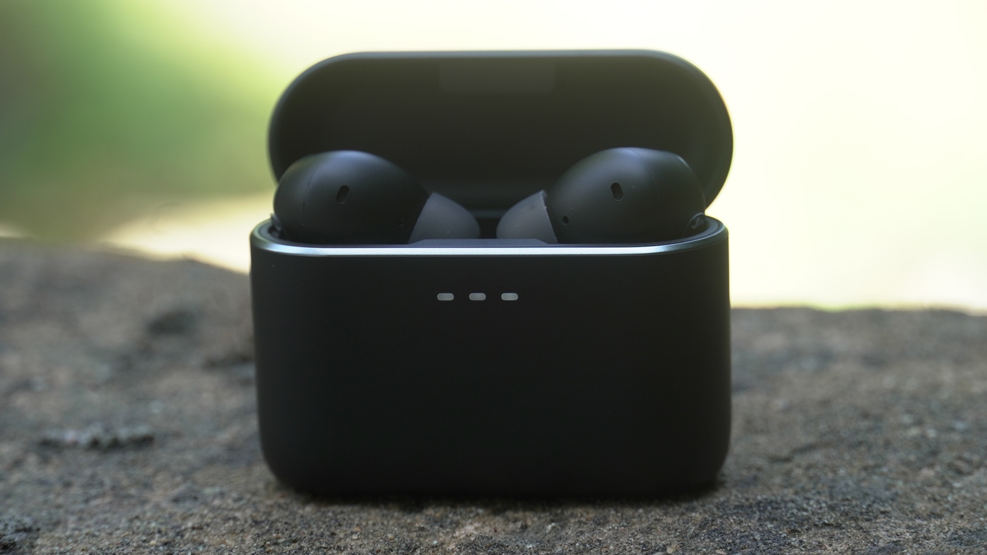 Sleek Cambridge Audio Melomania A100 earbuds in their charging case, highlighting sophisticated design