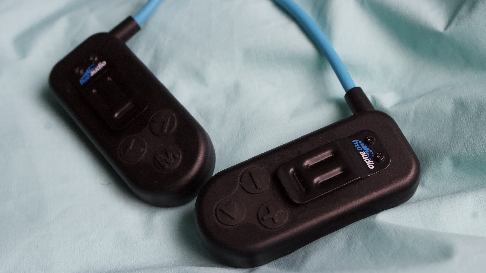 H20 Audio Sonar 2 Pro device worn by a swimmer in a pool, highlighting its sleek design and underwater use.